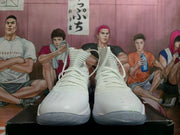 Front view of white high-top basketball shoes with lace-up fronts and speckled outsoles