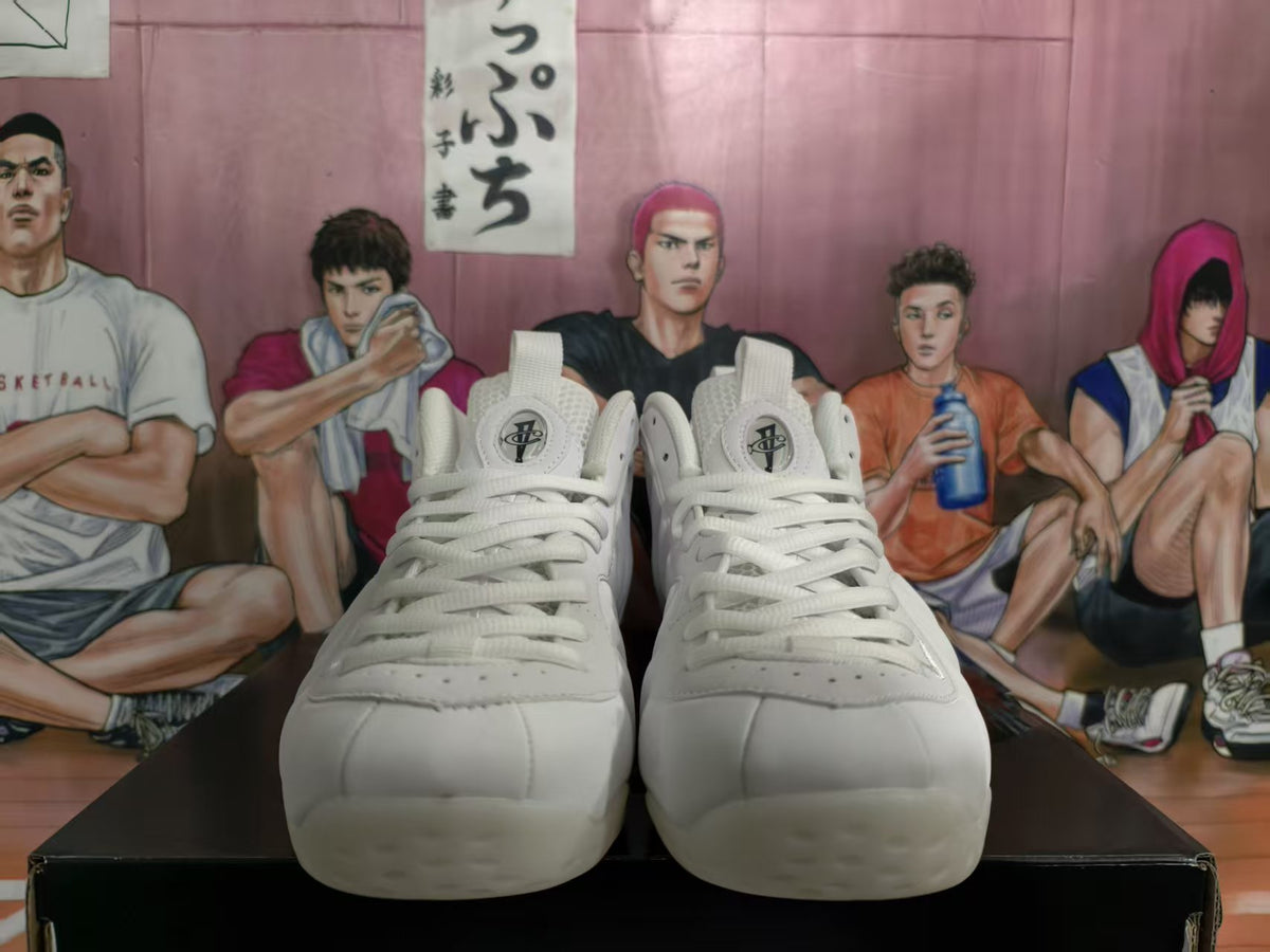 Front view of a pair of white high-top basketball sneakers with lace-up closures and padded tongues.
