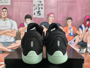 Rear view of black Jordan basketball sneakers with pale mint-green heels and soles.