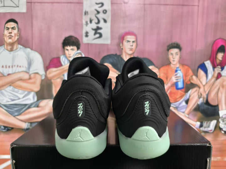 Rear view of black Jordan basketball sneakers with pale mint-green heels and soles.