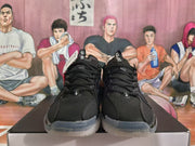 Front view of black lace-up basketball shoes with perforated panels and translucent outsoles.