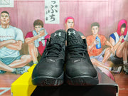Front view of black and gray basketball sneakers showing the SC markings, laces, textured toe panels, and patterned outsole.