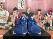 Front view of blue and white Nike basketball sneakers with textured uppers and white tongue logos
