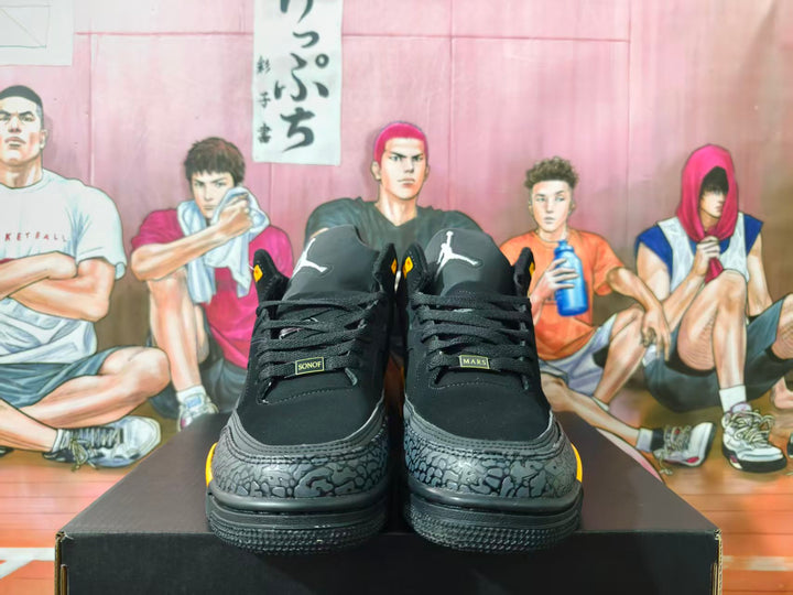 Front view of black high-top sneakers with gray elephant-print toe panels and yellow accents