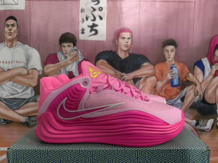 Side view of pink Nike basketball shoes showing the swoosh, layered sole, and structured side panels.