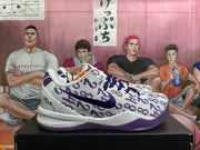 Side view of white Nike Kobe shoes with purple number-patterned uppers and purple Swoosh logos.