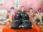 Front view of black and white Nike sneakers showing black laces, tongue branding, contrasting white trim and textured toe outsoles.