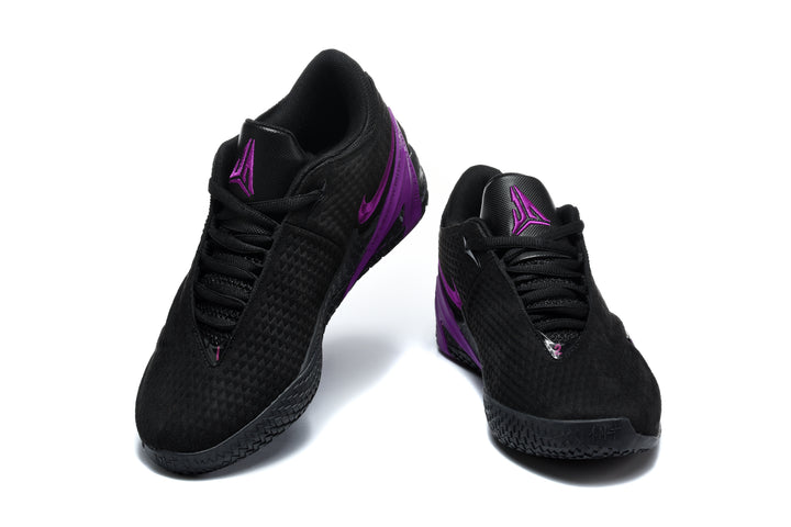Pair of black low-top Jordan-style basketball shoes with purple accents, front three-quarter view