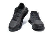 Front and top views of the dark lace-up On Cloudtilt Remix sneakers.