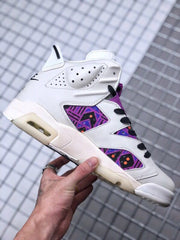 Side view showing the white upper, purple patterned panels, black laces, and off-white sole.