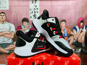 Side view of black, white, and red Nike Zoom Freak 1 basketball shoes