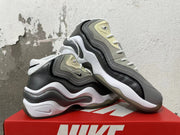 Pair of grey and white Nike sneakers with sculpted midsoles