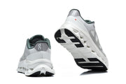 Rear and outsole views of white and gray On sneakers