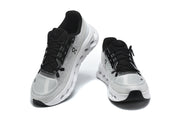 Pair of grey On Cloudmonster 3 shoes viewed from the front