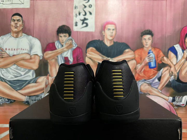 Rear view of black basketball shoes with gold heel accents