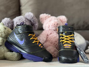 Front three-quarter view of the pair, showing the high-top construction, lacing and black-and-purple color scheme.