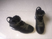 Angled front view of the black sneakers highlighting the perforated toe boxes and lace arrangement.