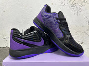 Angled view of the black and purple basketball shoes, including the patterned upper and side Swoosh.