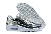 Nike Air Max 90 sneakers showing the silver and black upper, outsole, and visible cushioning window.