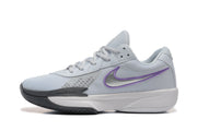Side view of a pale grey Nike tennis shoe with a purple-outlined Swoosh and dark outsole detail