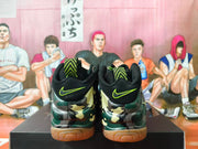 Rear view of camouflage basketball shoes with black heel panels and neon embroidered logos.