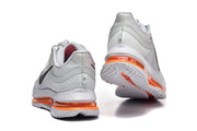 Rear and outsole views of grey Nike Pegasus Premium shoes with orange midsole accents.