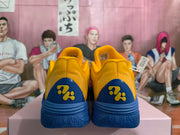 Rear view showing textured yellow heel panels and decorative blue heel details