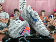 Angled view of grey and white basketball shoes with colorful side accents