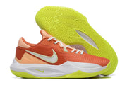 Orange, white, and bright yellow-green basketball shoe shown beside its tread.