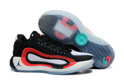 Black, white and red Jordan Luka 4 basketball shoes shown with the translucent outsoles visible.