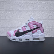 Side view of a white and pink Nike Air More Uptempo sneaker with sprinkle-style accents.