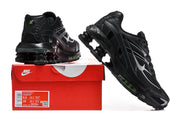 Black Nike Shox Ride 2 sneakers shown from multiple angles on a red box; the box label displays sample size markings.