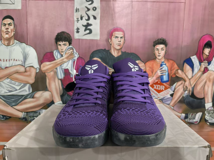 Front view of purple Nike basketball sneakers with matching laces and translucent outsoles.