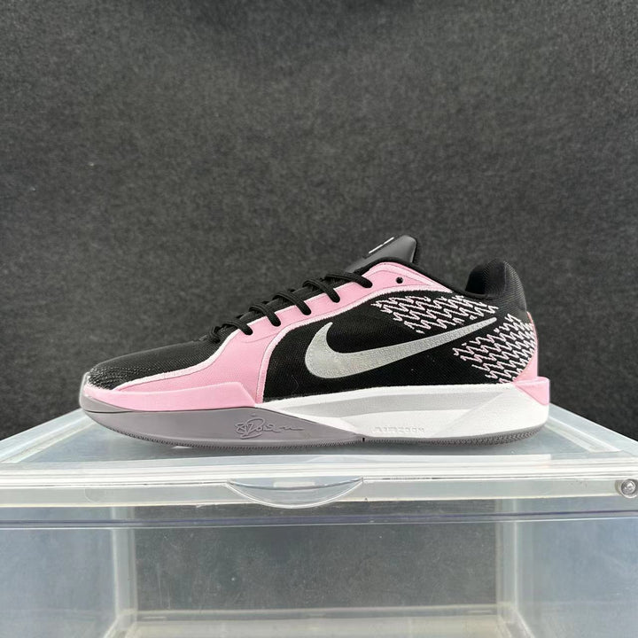 Black and pink Nike basketball sneaker with a white Swoosh, patterned side panels, Sabrina signature detail, and Zoom branding on the midsole.