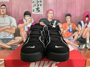 Front view of black and white high-top basketball sneakers with layered black laces and contrasting trim.