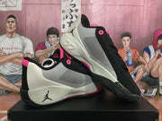 Angled view showing the light side panels, black overlays, Jordan logos, and textured outsole