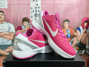 Angled view of the pair highlighting the textured pink uppers, white Swoosh branding, and sculpted heel panels.