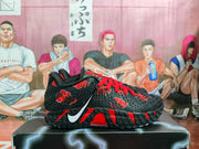 Side view of a black basketball sneaker with red laces, a white Nike Swoosh, red accents, and visible Zoom branding.