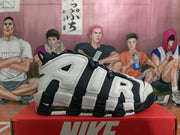 Side view showing oversized AIR lettering and visible cushioning units on a Nike basketball shoe.