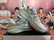 Pair of gray Nike basketball sneakers displayed from the side and at an angle