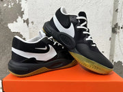 Pair of black Nike sneakers with white Swoosh accents and gum-colored outsoles