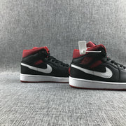 Three-quarter view of the pair showing the black and red upper, white Swooshes, and white midsoles.