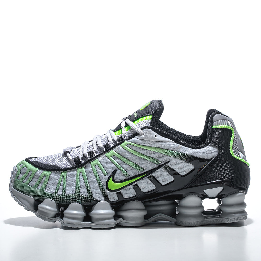 Side view of grey and black Nike Shox TL sneakers with neon green accents and a segmented sole.