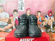 Front view of a pair of black high-top sneakers with lace-up closures.