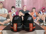 Rear view showing GT heel logos, red vertical heel accents, black collars, and textured black outsoles.