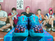 Front view of the sneakers showing the patterned toe, blue laces, and red number graphics.