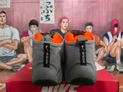 Rear view of gray high-top sneakers with bright orange lining, black heel details, and vertical branding tabs.