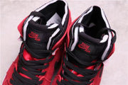 Top view showing black tongues and laces with red tongue branding and contrasting white padding.