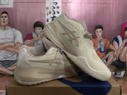 Pair of cream and taupe ASICS basketball shoes shown from the side and at an angle