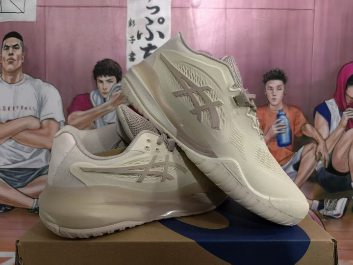 Pair of cream and taupe ASICS basketball shoes shown from the side and at an angle